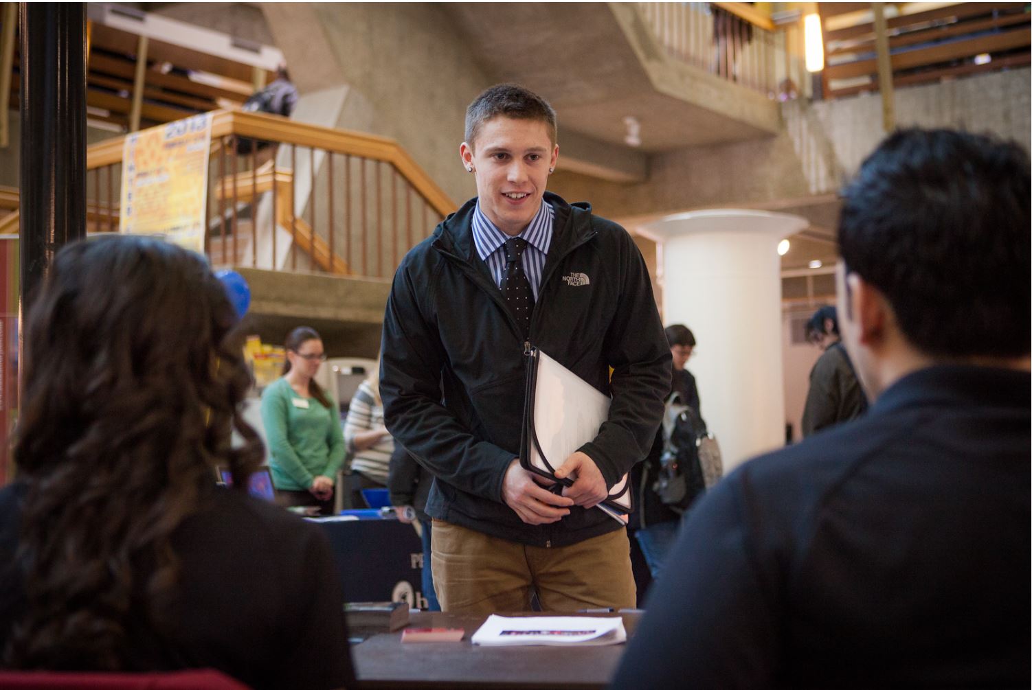 Joshua Liebhober speaks to potential summer job opportunities at the Student Job and Internship Fair provided by UAF Career Services.