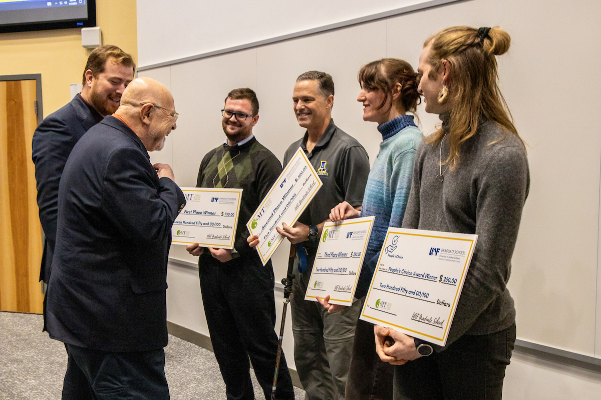 Winning graduate students interact with members of the judging panel during the annual 3-Minute Thesis event on Friday, November 3, 2023 in the Schaible Auditorium. UAF Photo by Marina Barbosa Santos