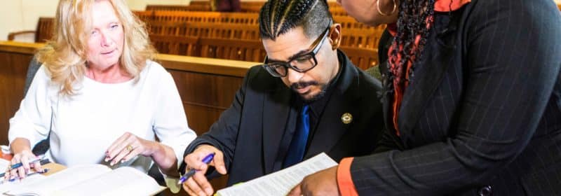 People working in a court room with paperwork