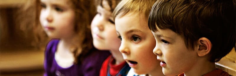 Four young children in a classroom