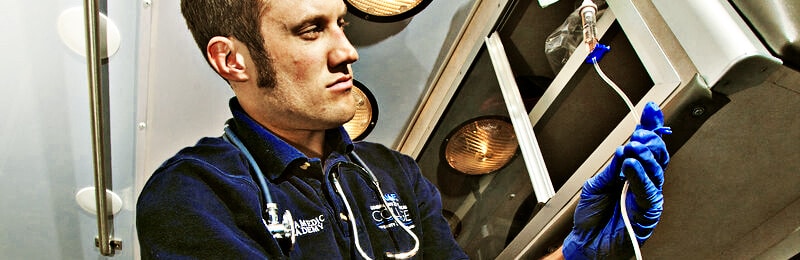 Medical man looking at a tube