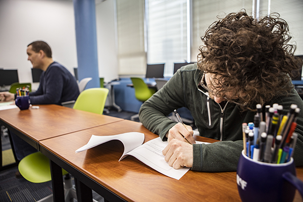 Students taking exams in the exam services area