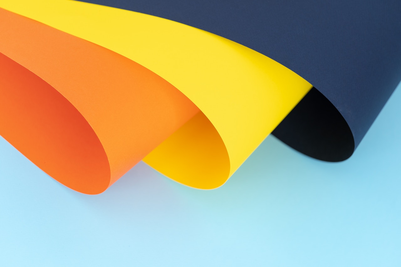 orange yellow and navy blue paper rolled.