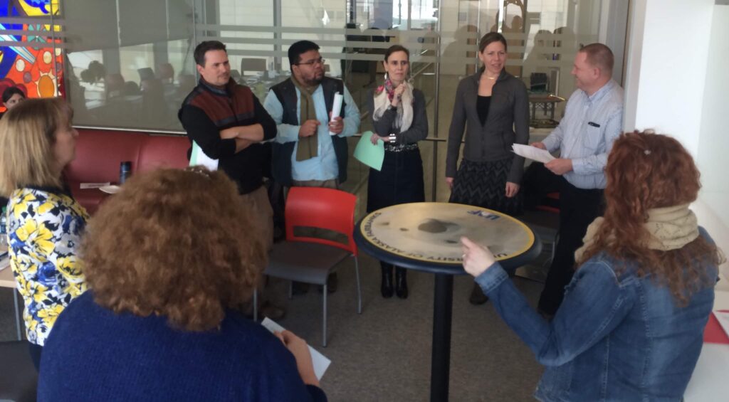 In March 2016 at the iTeach faculty development workshop, attendees were given roles of historic Greek persona to play out the Siege of Athens (405 BCE). Pictured above are various Athenians, who against all odds survived the food shortages while still defending democracy. There was initial unease in playing such removed roles, but within minutes there was full bodied debate echoing the voices of the past from the Athenian Pynx