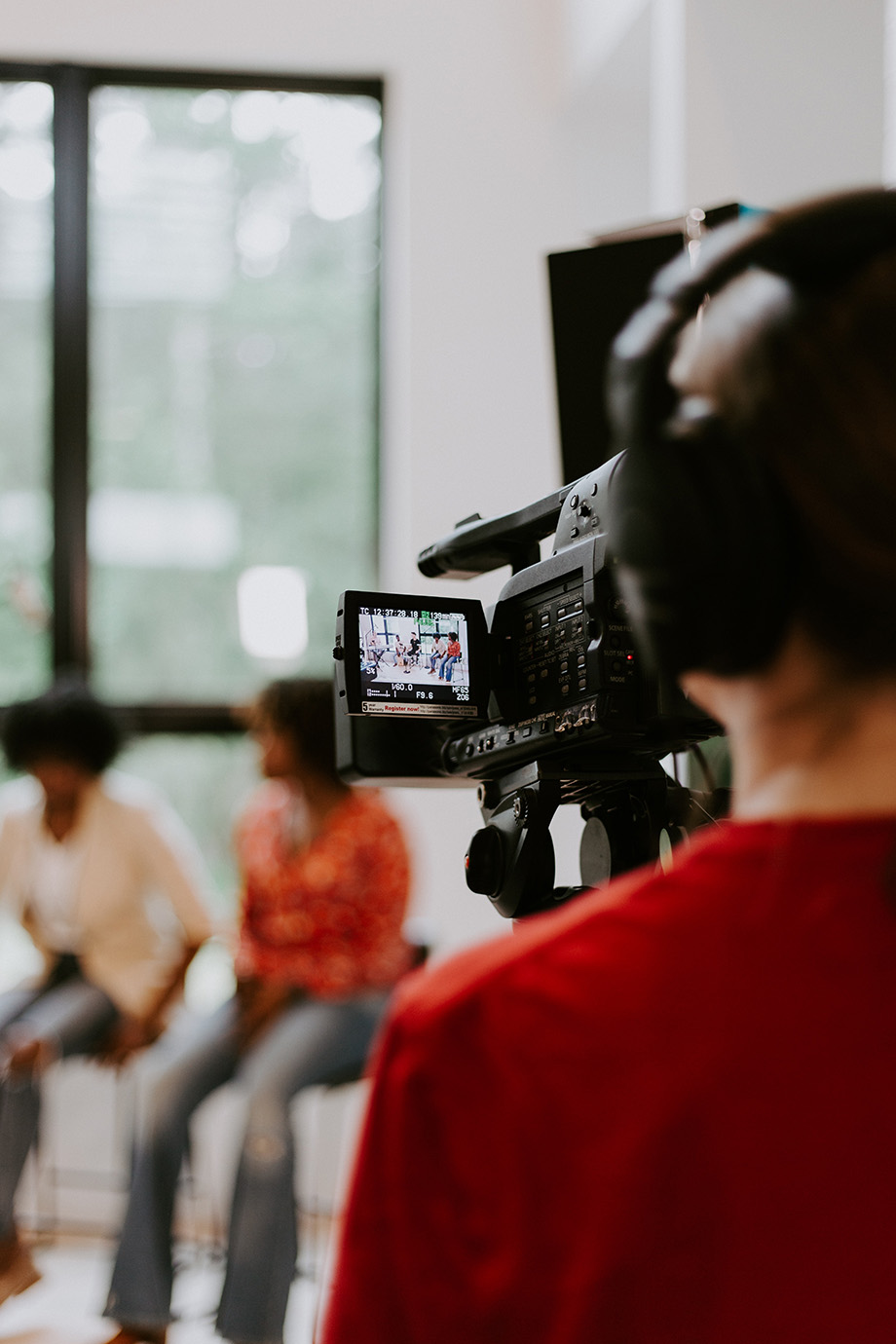 The back of a person video taping a group of people