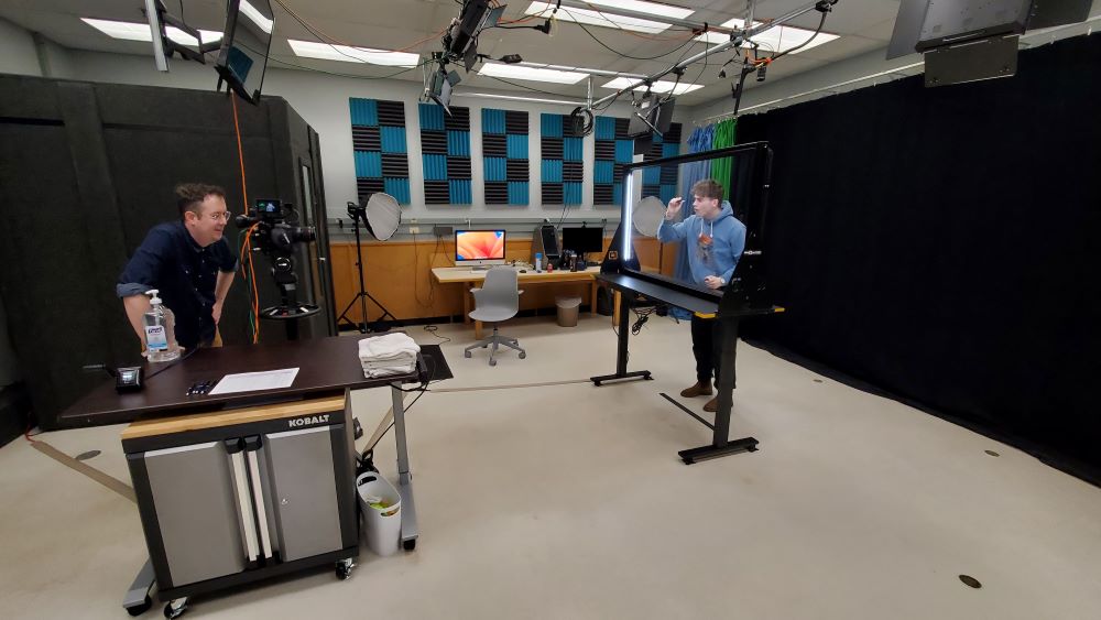 CTL Media Designers Eric Lonn and Ian Borowski prepare the DIY lightboard for a faculty presentation