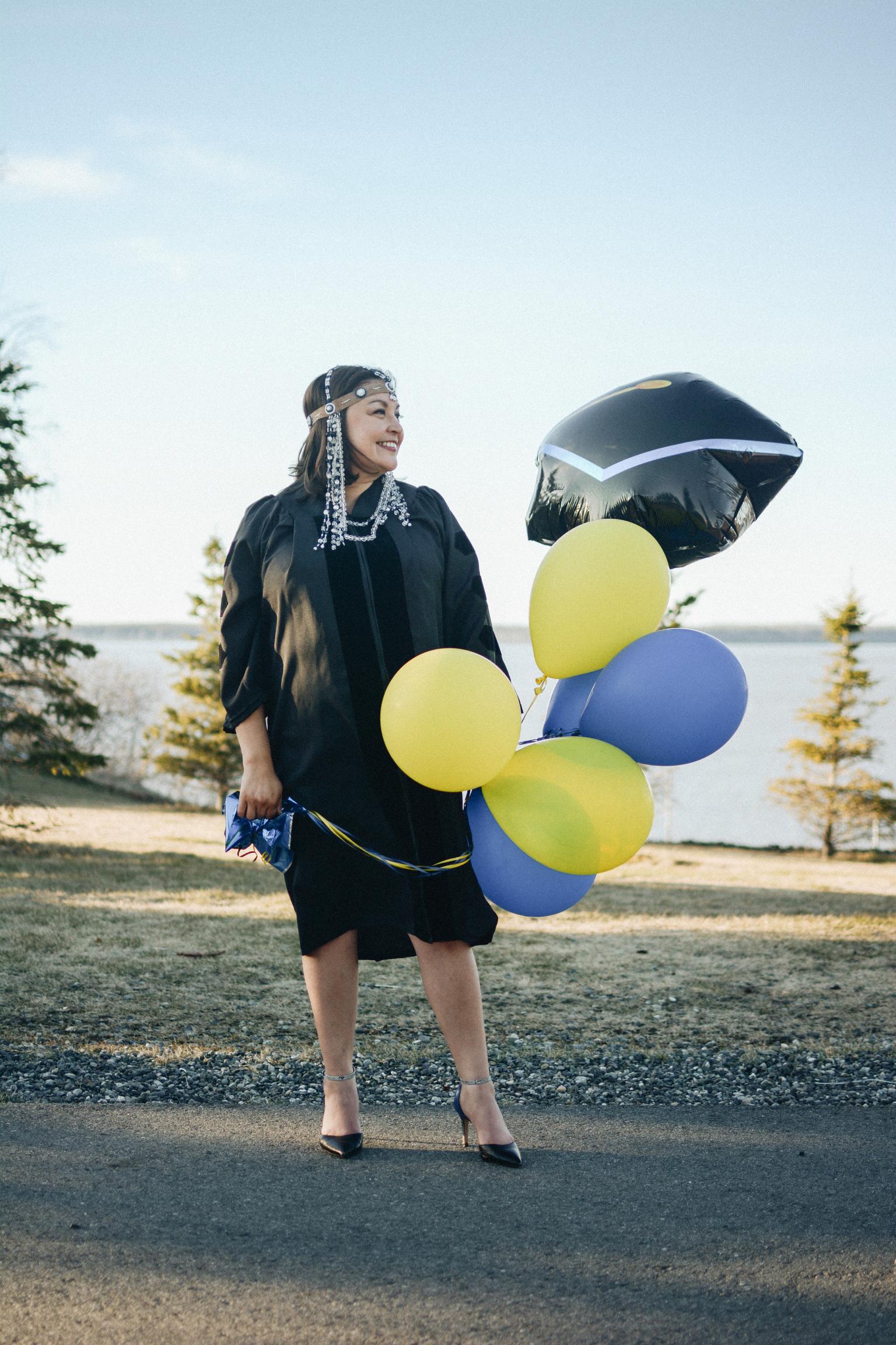 Graduate poses with balloons