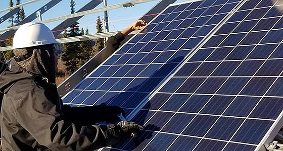 Students working on solar panels. Photo credit TCC.