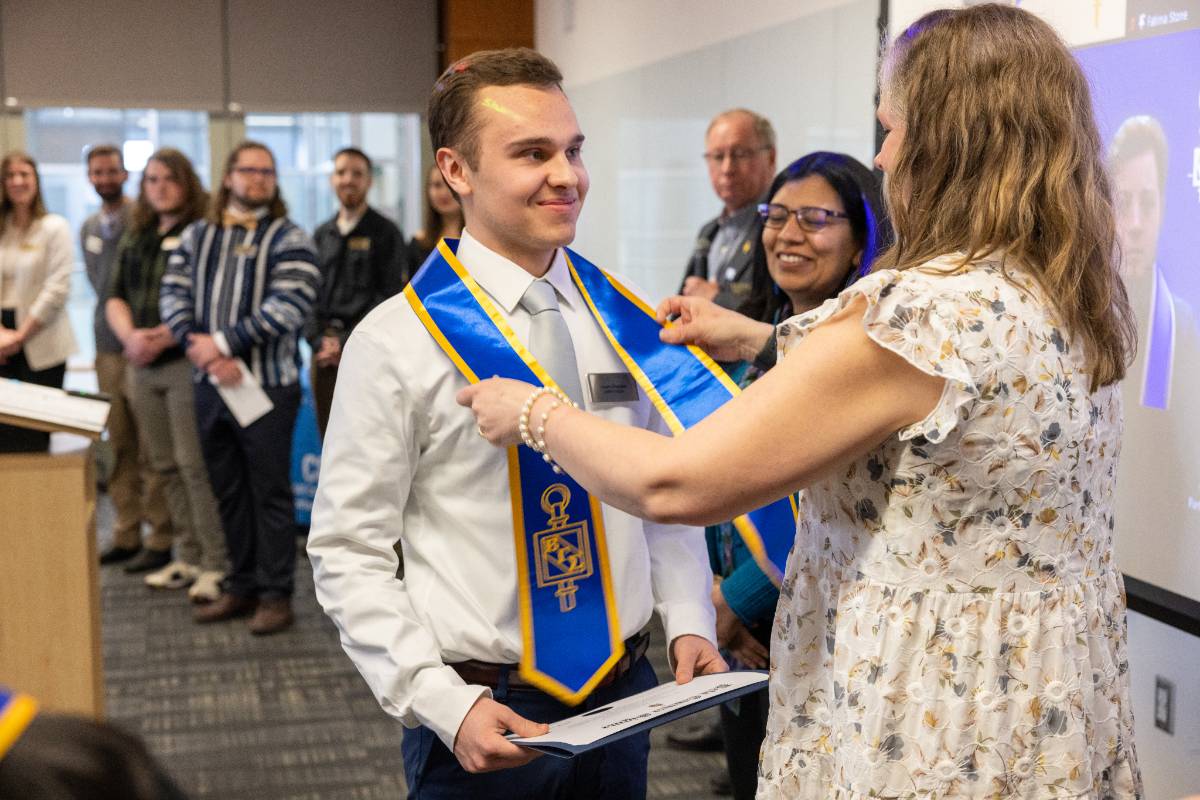 Honors student receiving sash at ceremony