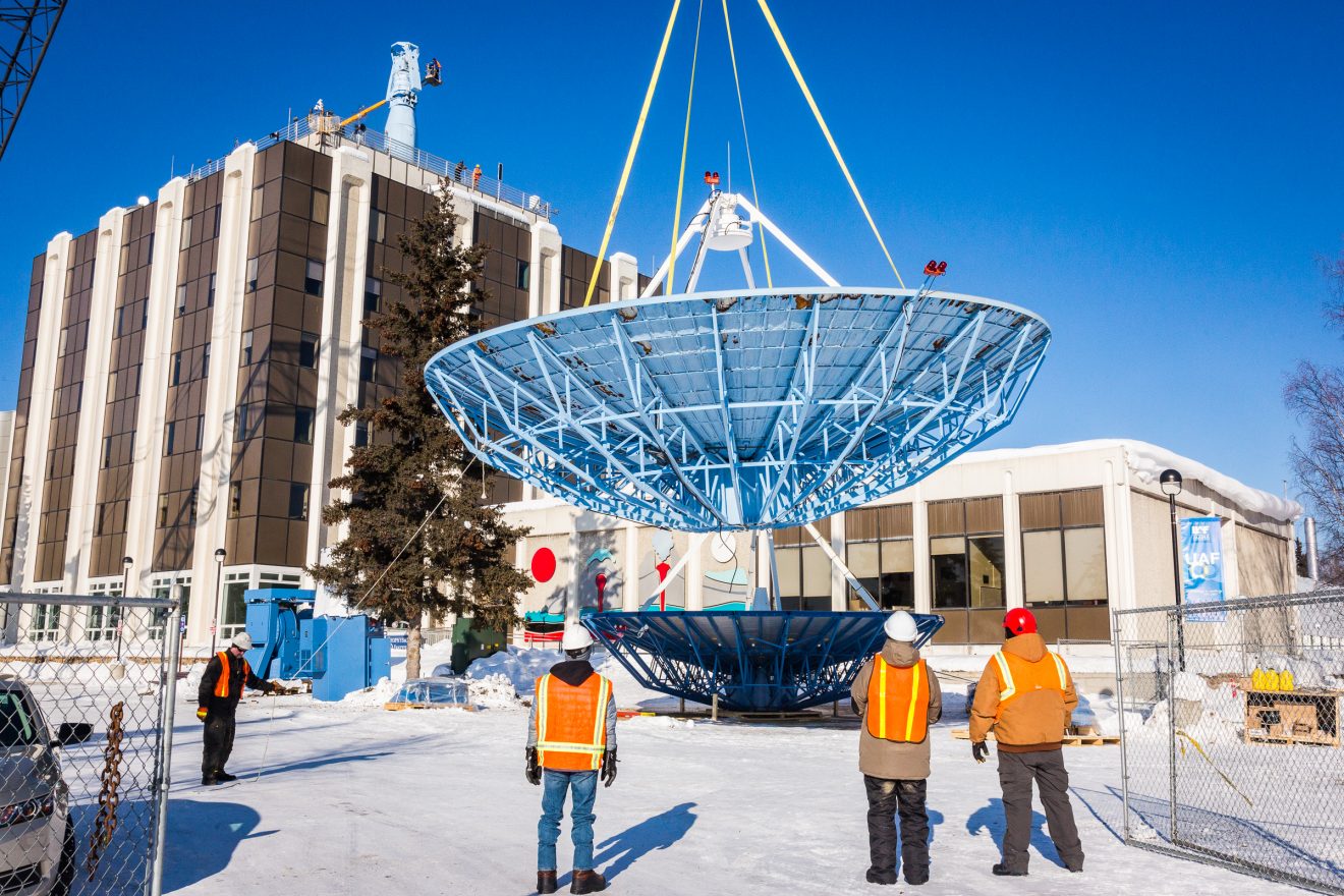 A crane lowers the old 10-meter antenna from the roof of the Elvey Building on Thursday, March 16, 2017, ending the dish's 25 years of service to the Geophysical Institute on the Fairbanks campus. A new 9-meter antenna will replace the retired dish and continue to retrieve scientific data from polar-orbiting satellites.