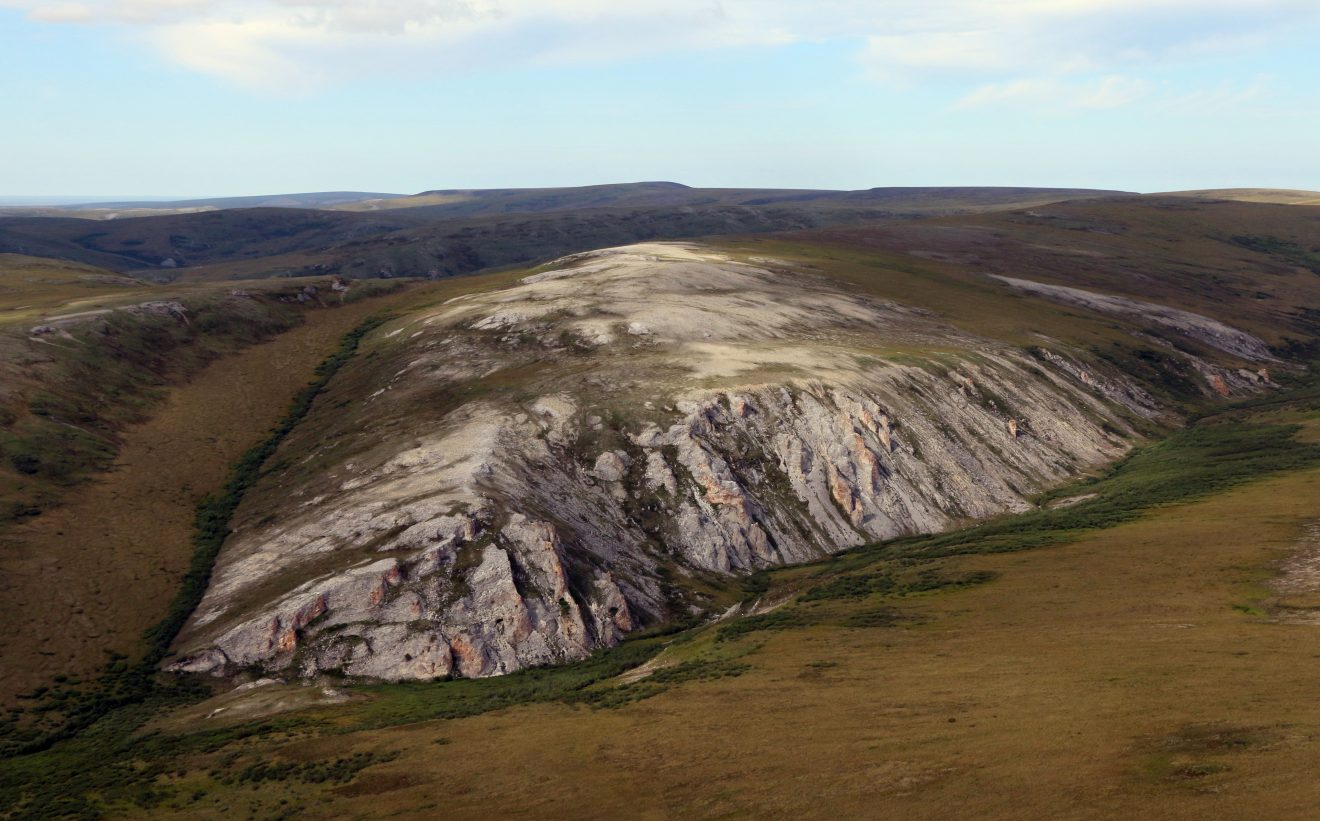 NPS photo by Jeff RasicAn aerial view of the Trail Creek Caves site on Alaska's Seward Peninsula. Analysis of a 9,000-year-old tooth from the site has broadened understanding of Alaska's early people.