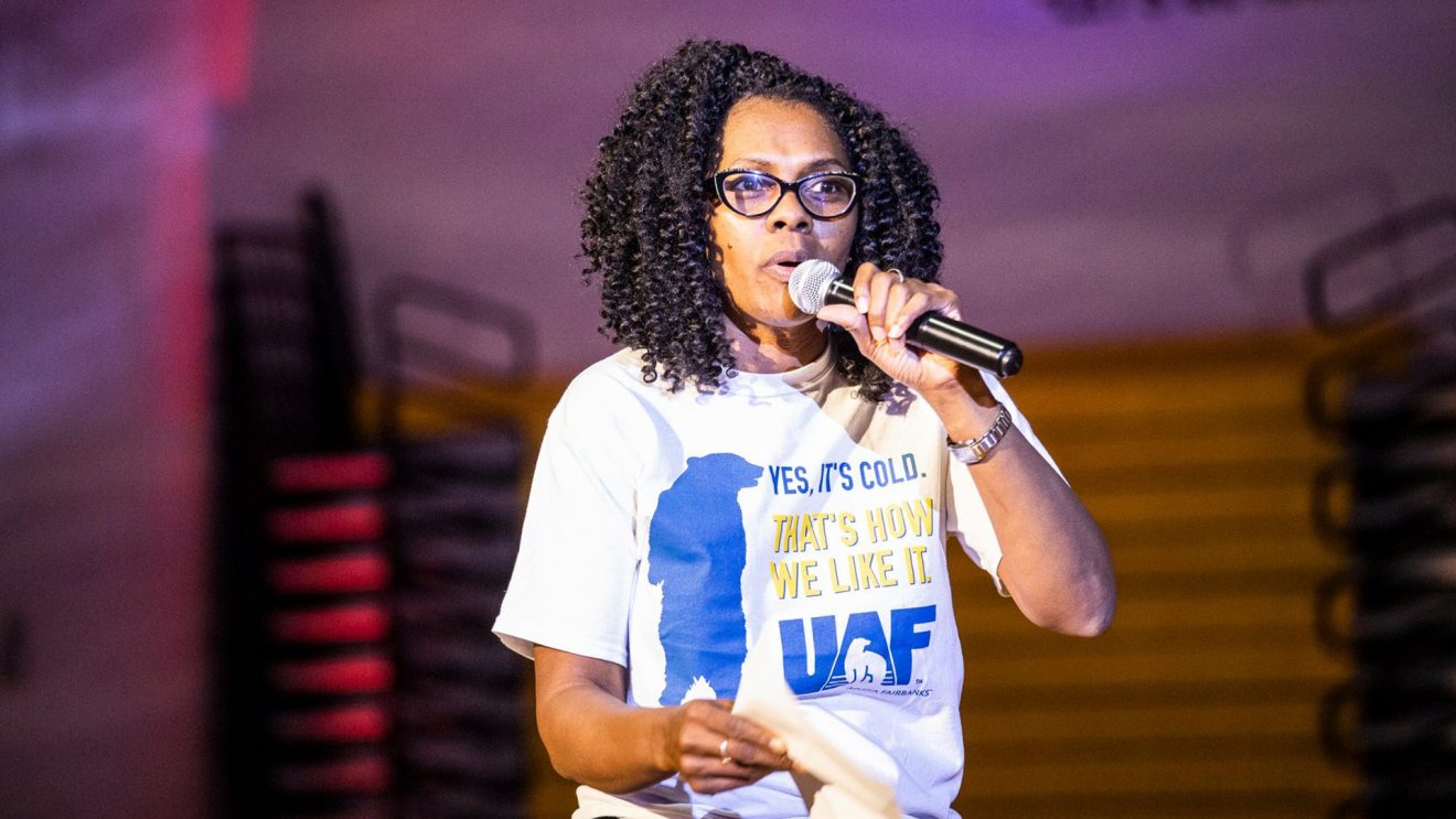 Terlynn Olds speaks into a handheld microphone