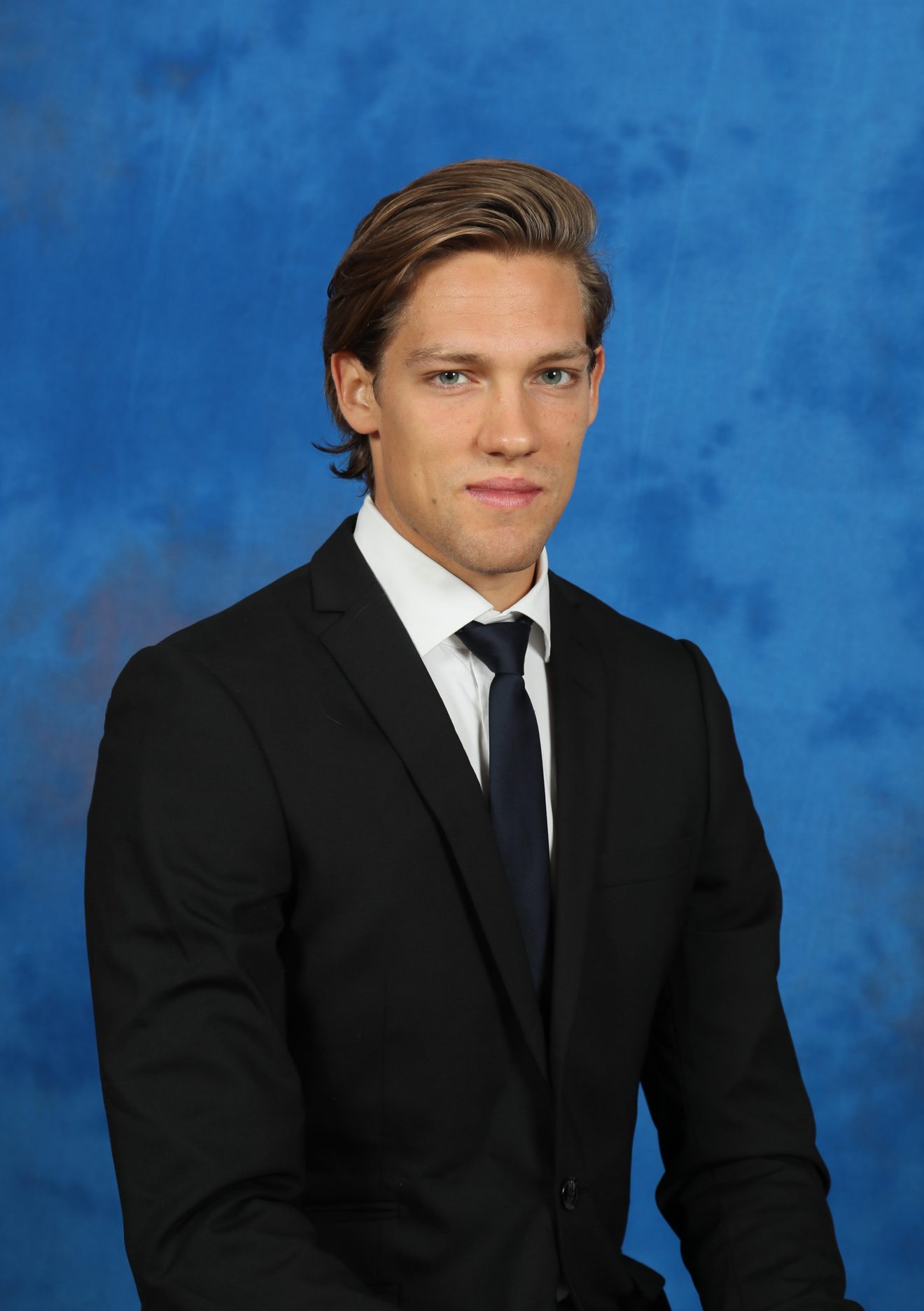 Anton Martinsson dressed in coat and tie.