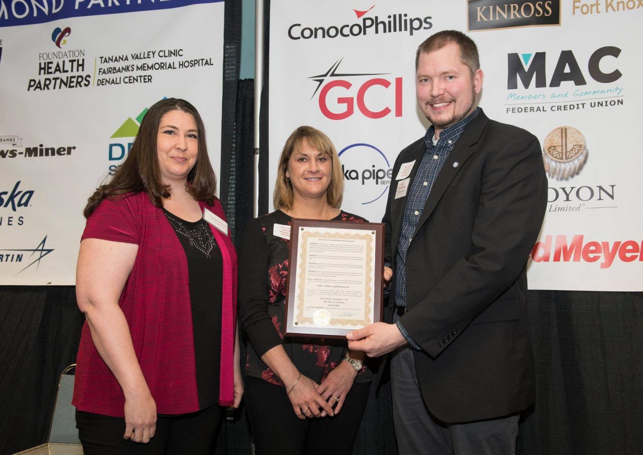 Amanda Wall, director of the bursar's office, accepts the Family Friendly Workplace award from FNSB Early Childhood Development Commission Chair Laralee Walston and FNSB Mayor Bryce Ward.