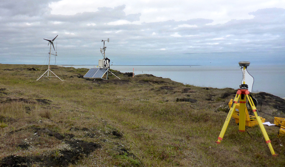 Three pieces of equipment on a treeless coast.