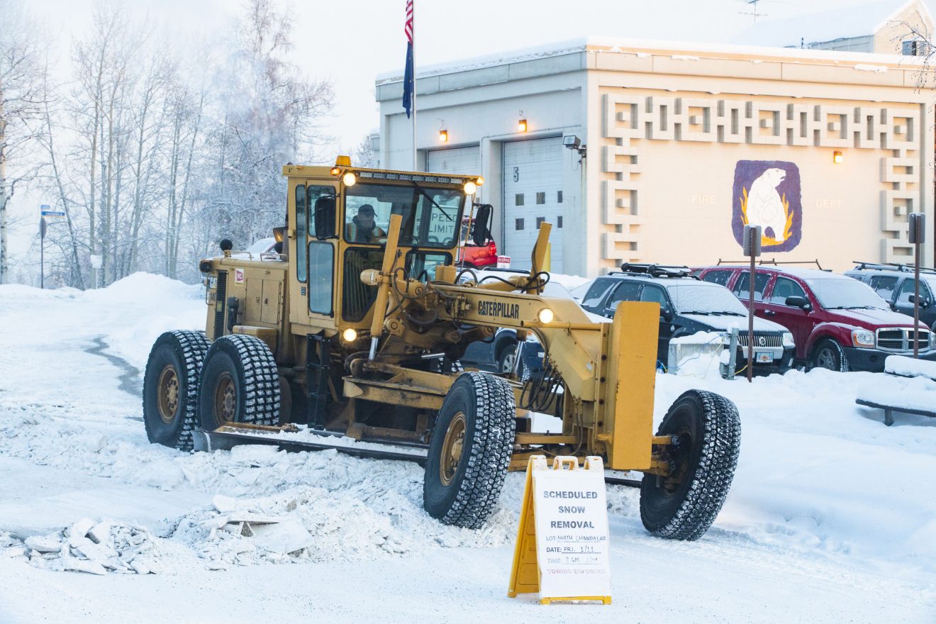 The Facilities Services grounds crew clear packed snow from the North Chandalar in January 2019.
