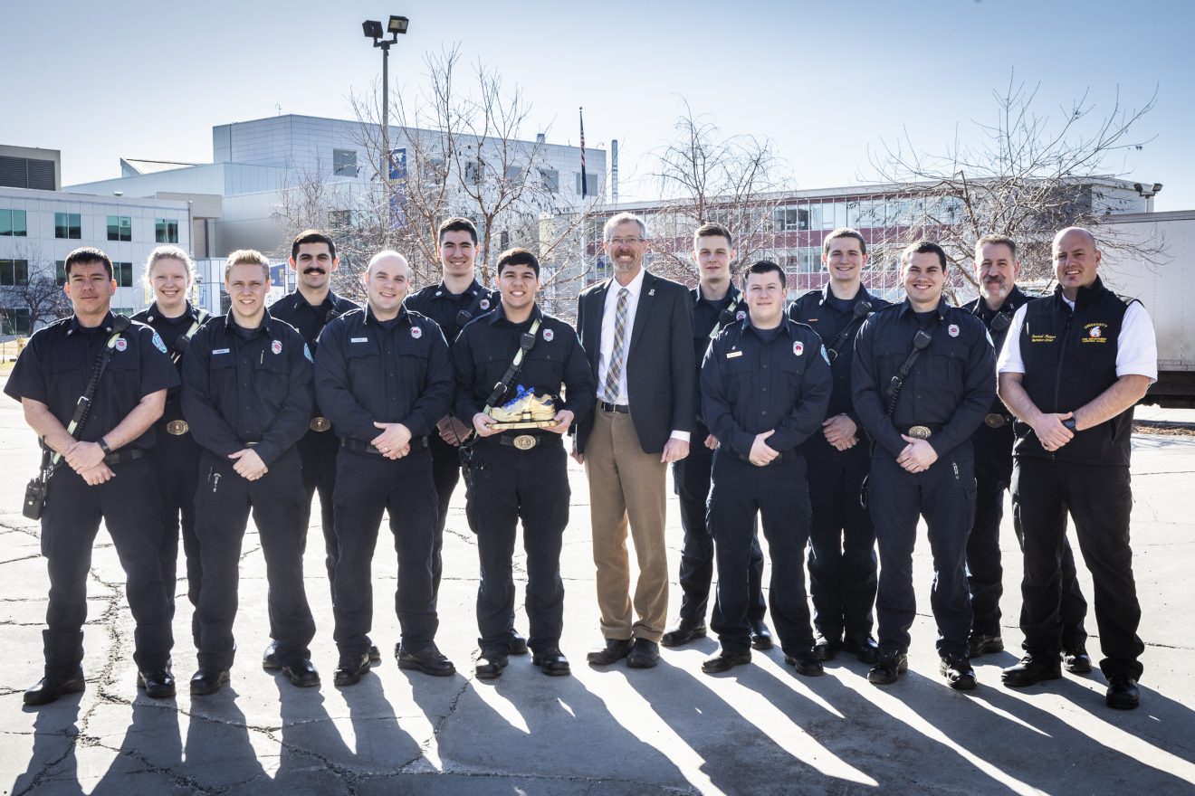 Fire Department Heart Walk team members standing with the Blue and Gold shoe.
