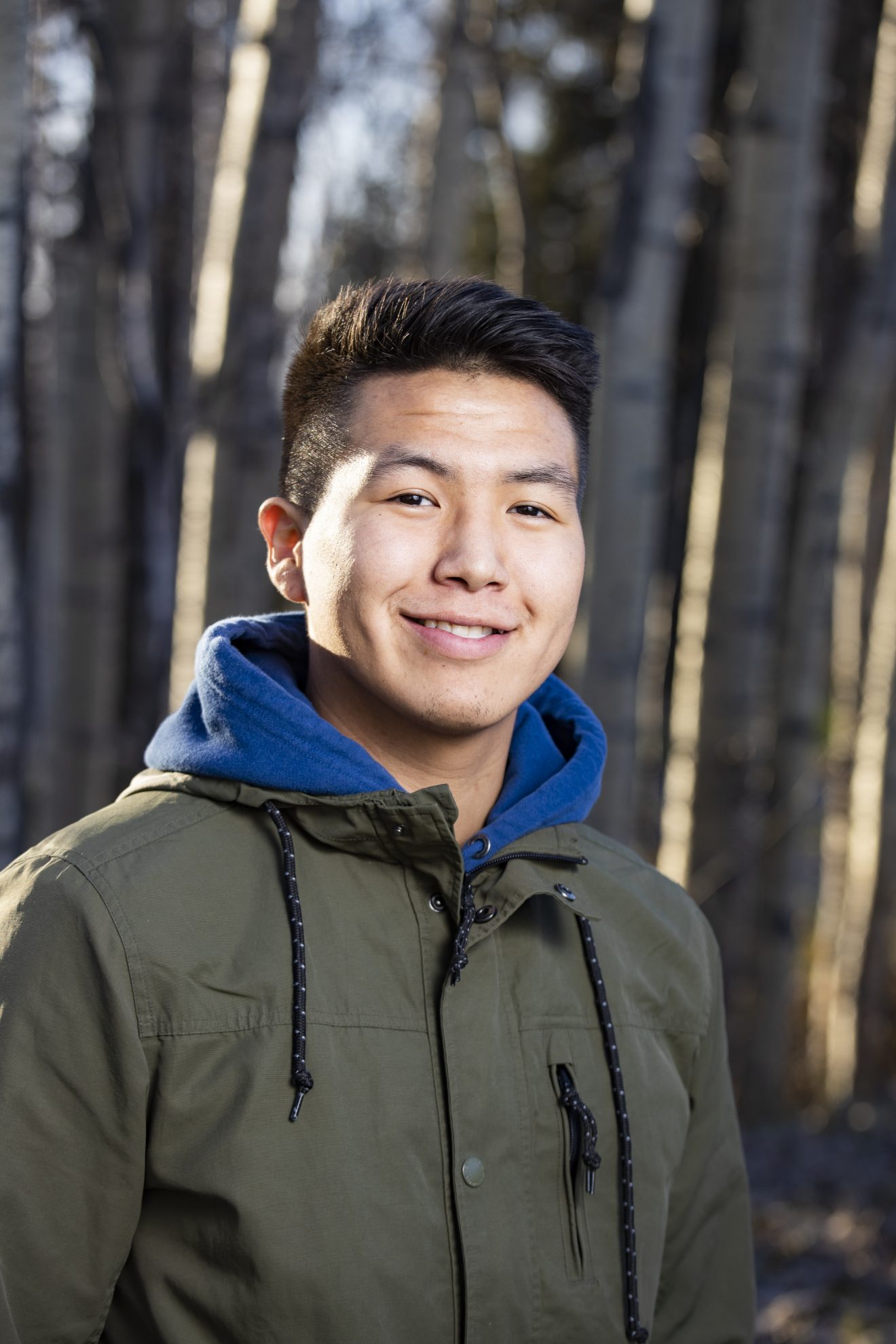 Elton Chanar. Dressed in warm clothing, posing outside on a fall day.