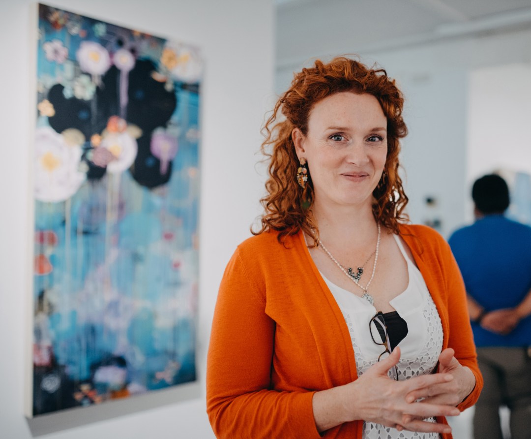 Madara Mason stands in an art gallery.