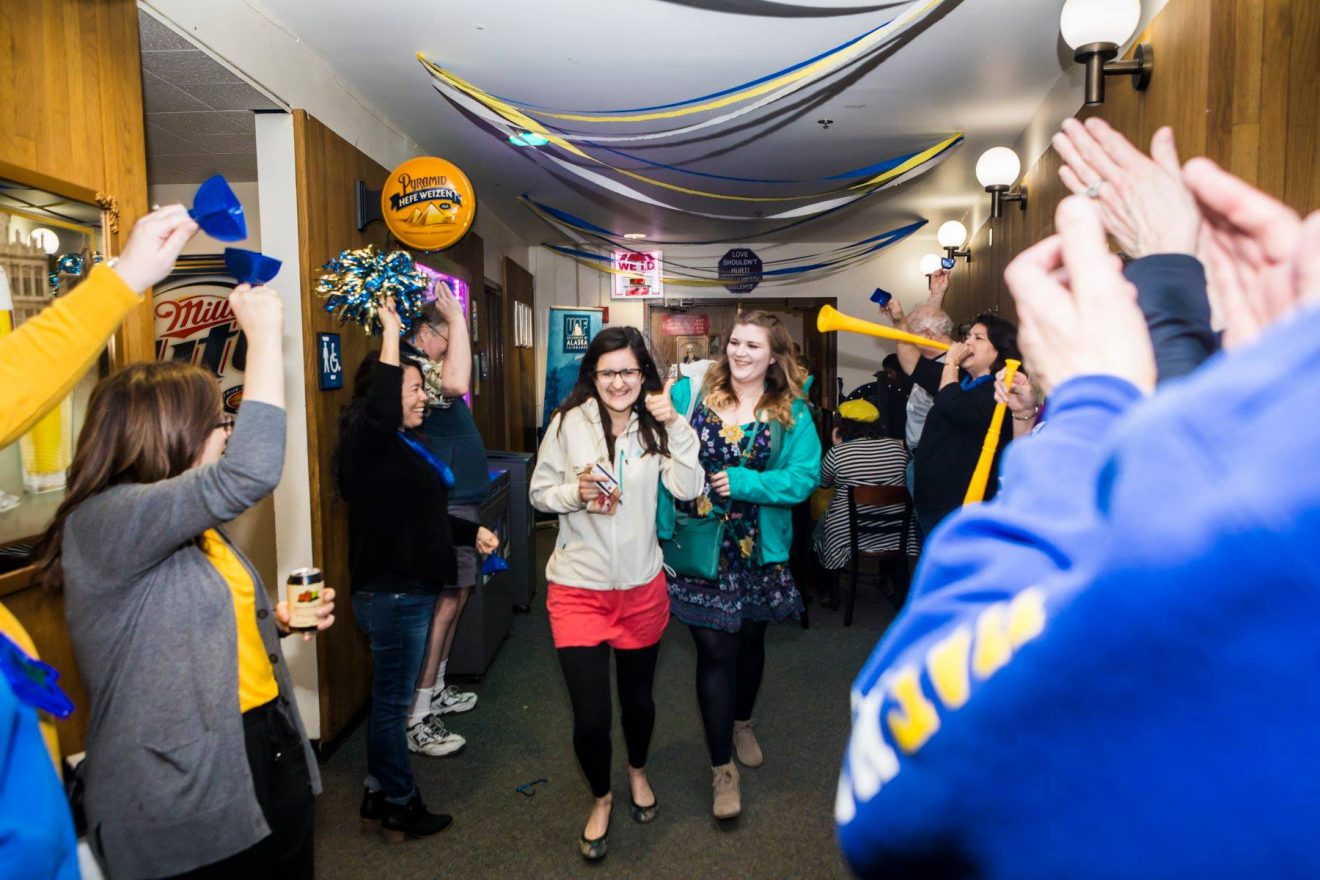 Students walk through a gauntlet on their way in to the Pub as part of Grad Bash 2018.