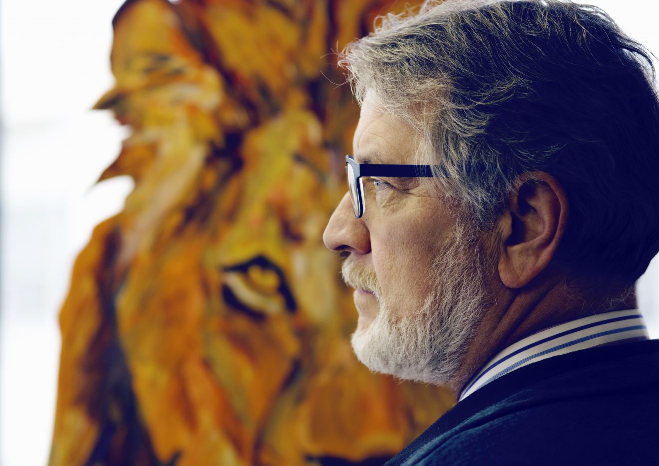 Todd Sherman, standing in front of one of his paintings