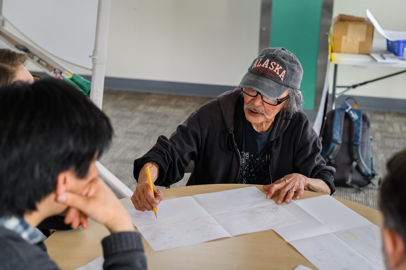 Walter Hill, a participant from Quinhagak, visualizes impacts of climate change through drawing in a group exercise.