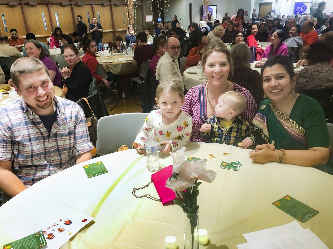 The family sits at a table with Provost Prakash.