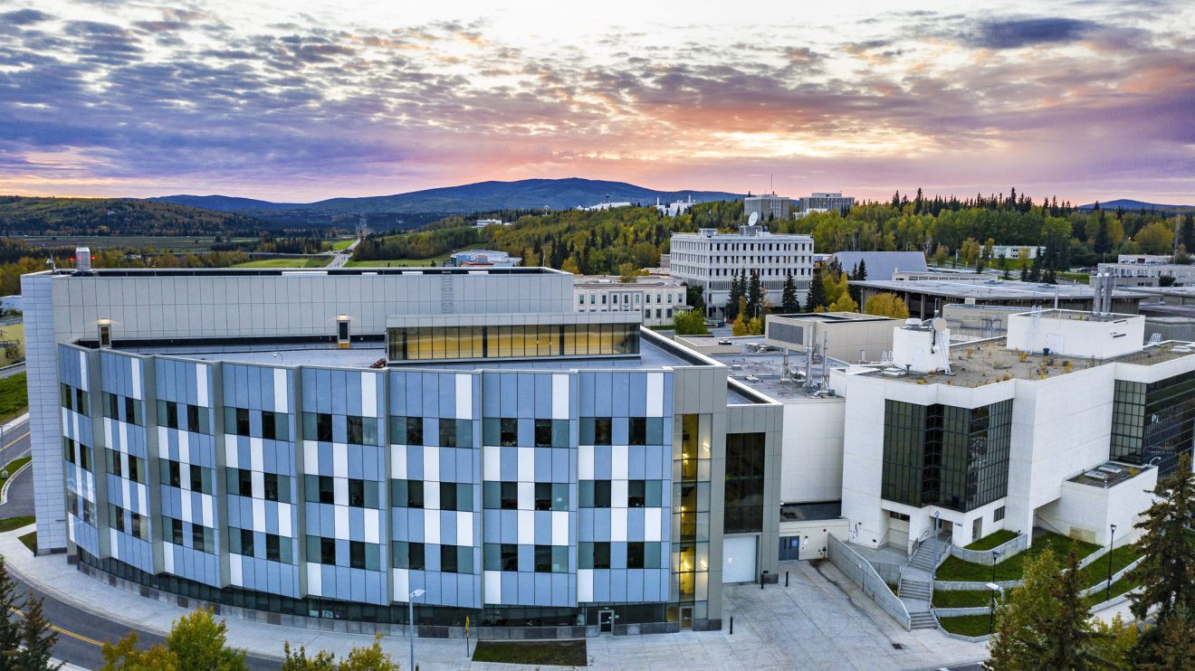 The engineering building in the foreground, with a sunset in the background