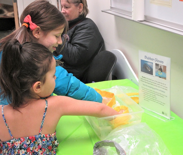Two children doing an experiment at a table.