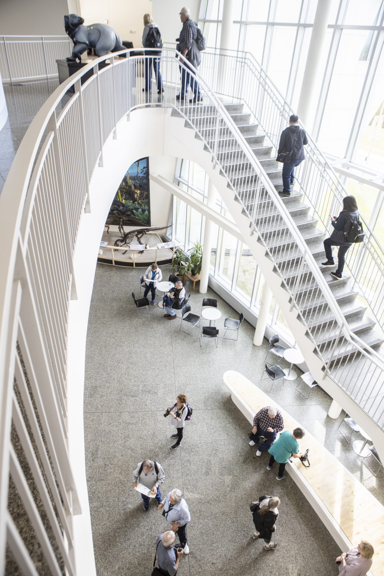 Photo of people on the ground floor and climbing the stairs to the second floor of the museum.