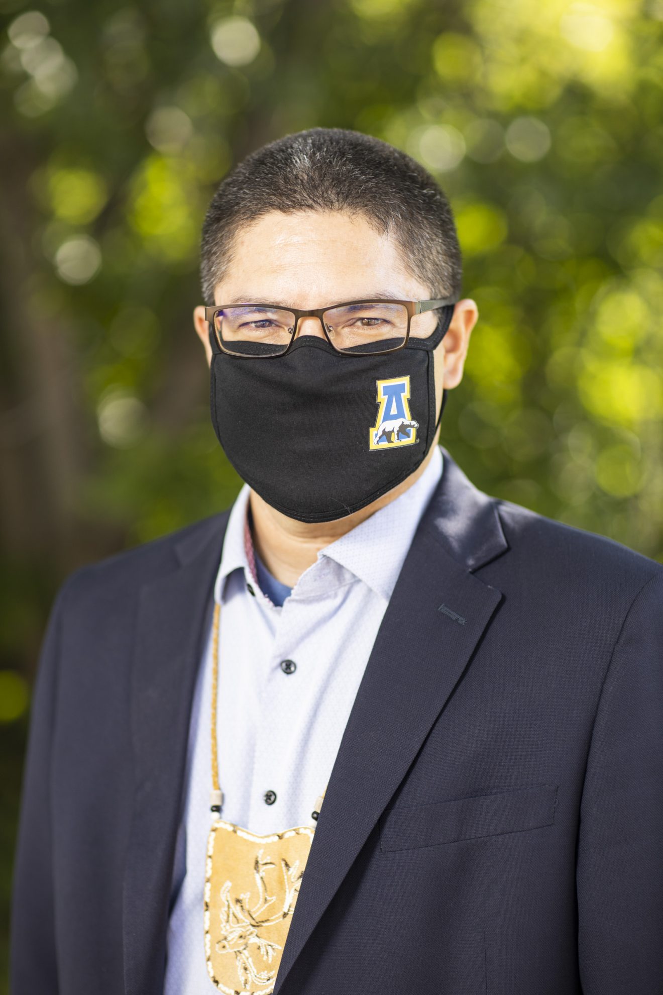 Head shot of Evon Peter wearing a COVID-19 mask