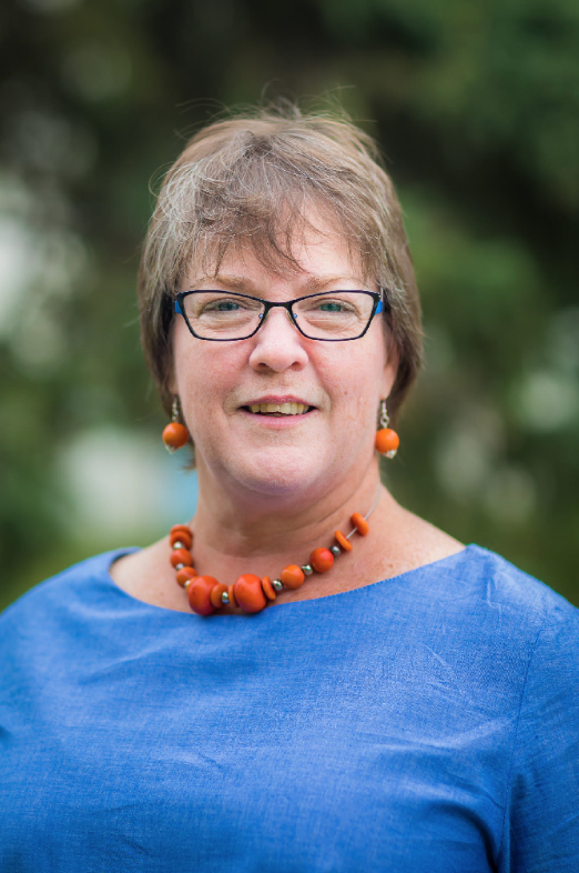 Head shot of a woman outside.