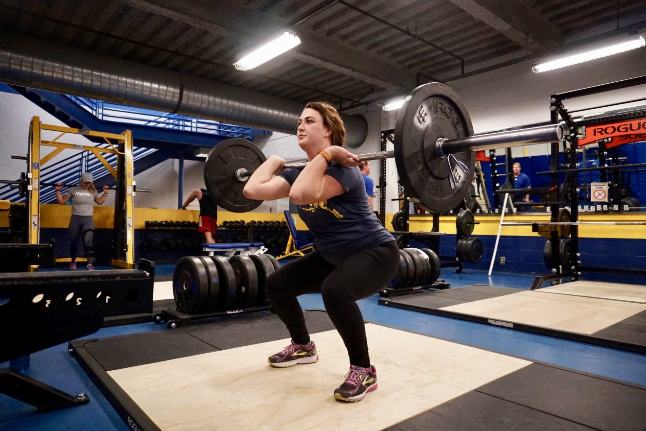 A woman practices weigh lifting in the SRC.