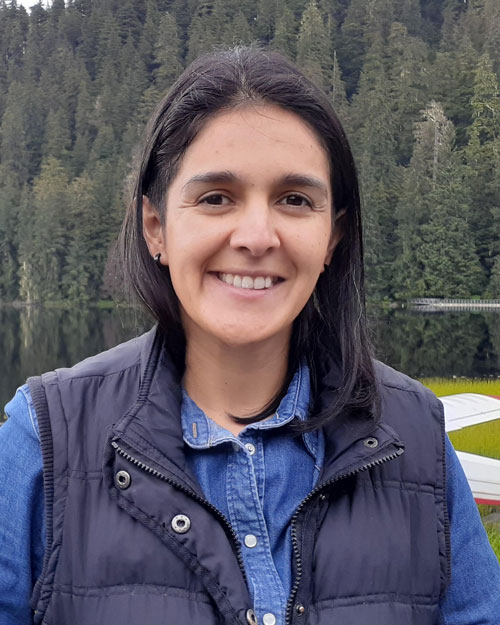 Head shot of a woman outside.
