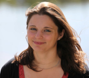 Head shot of a woman outside.