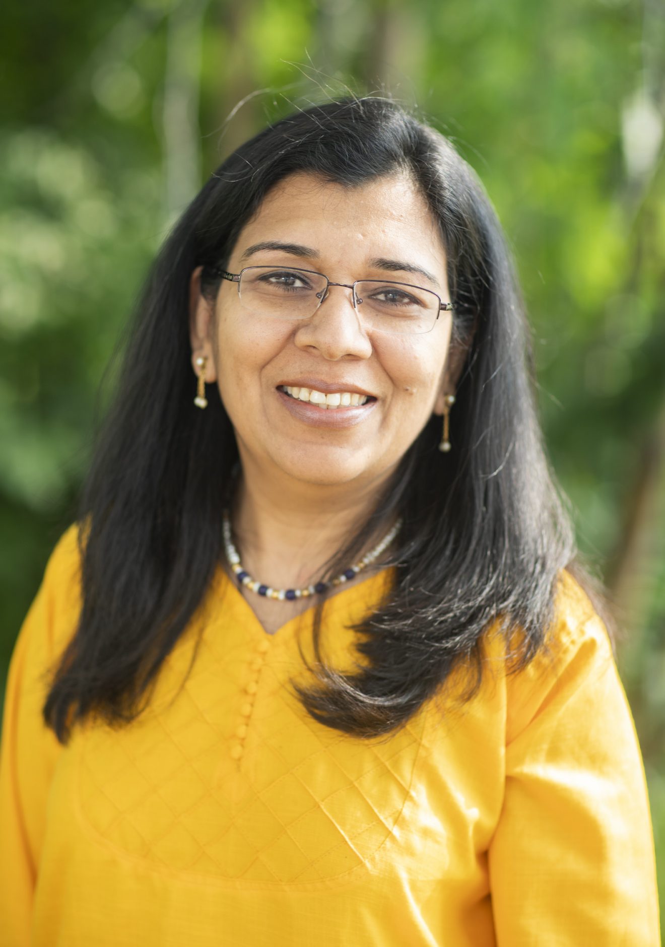 Head shot of a woman outside.