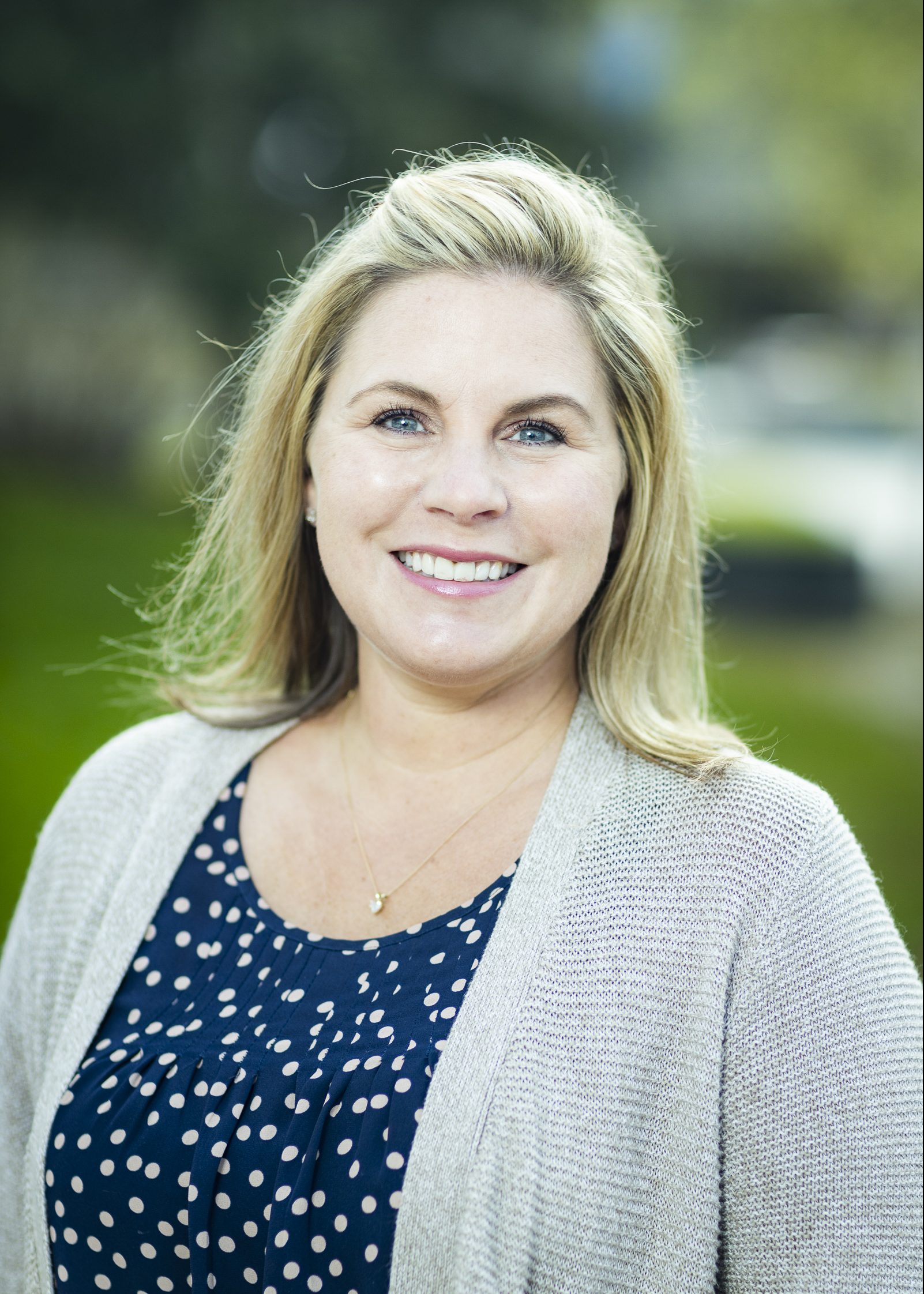 Head shot of a woman outside.