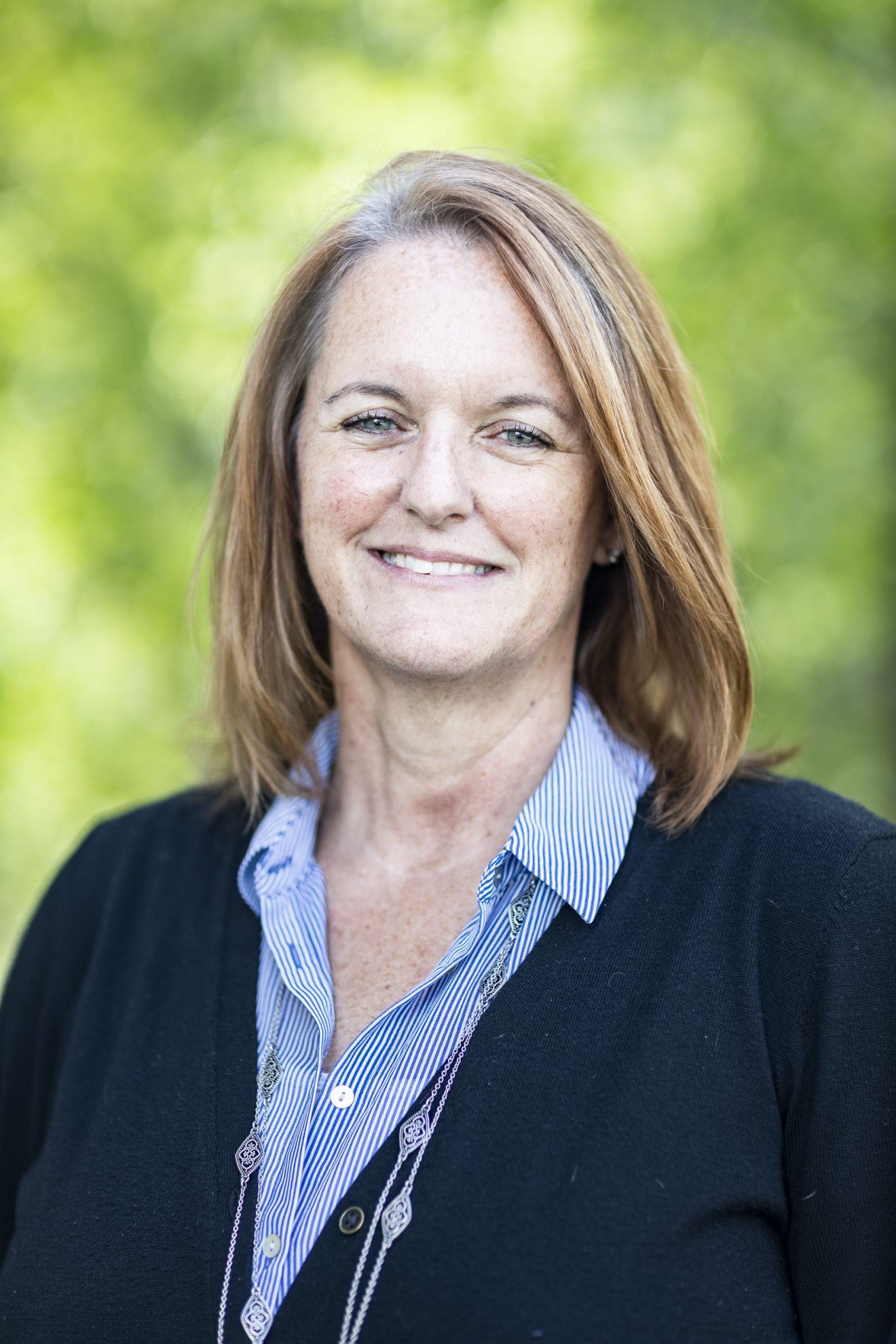 Head shot of a woman outside.