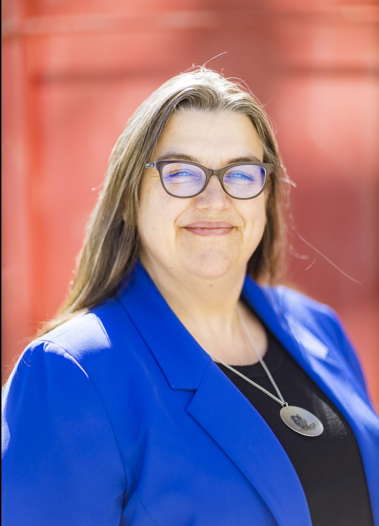 Head shot of a woman outside.