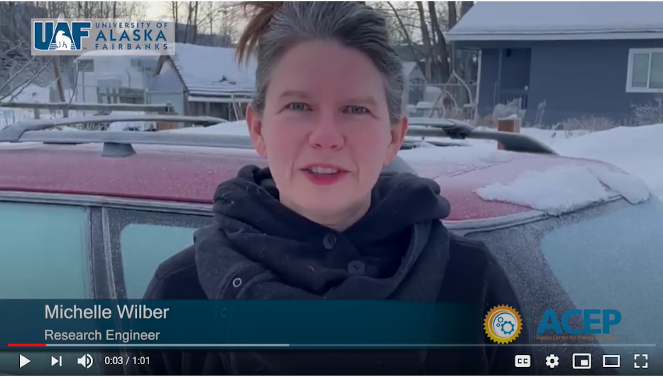 Screen shot of woman talking outside in winter.
