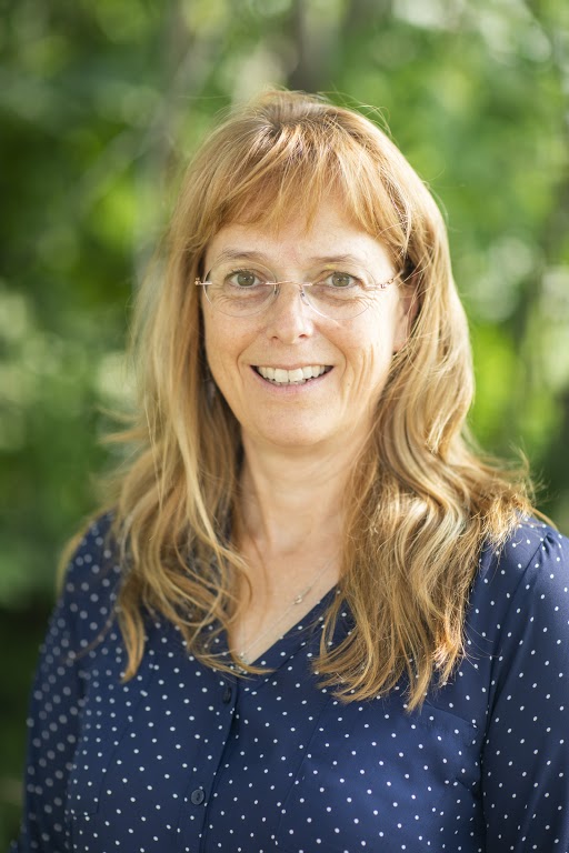 Head shot of a woman outside.