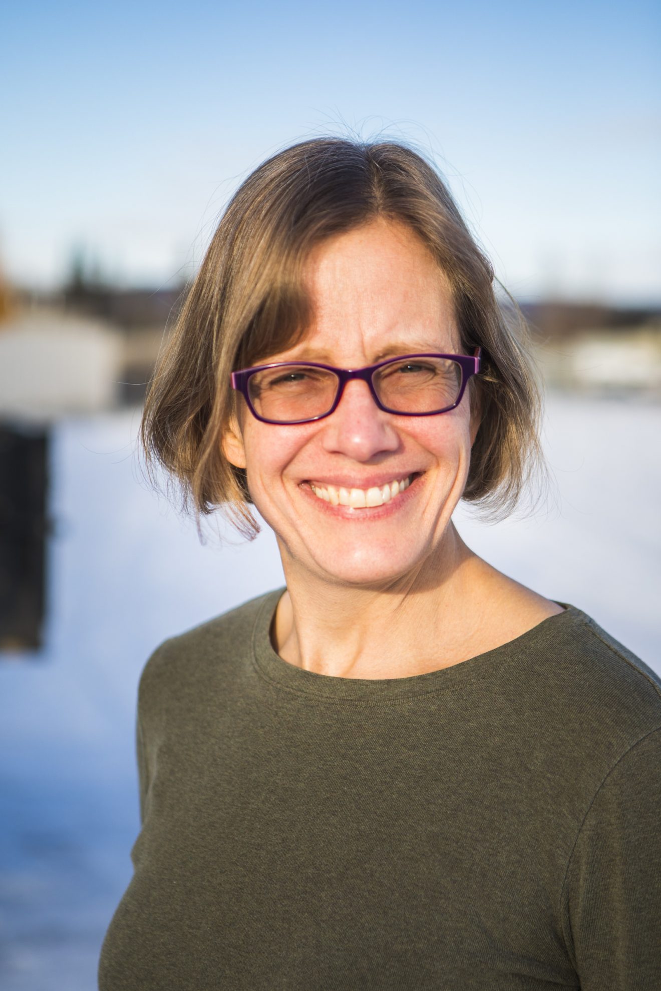 Head shot of a woman outside.