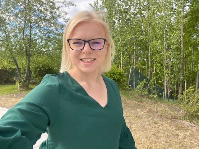 Head shot of a woman outside.