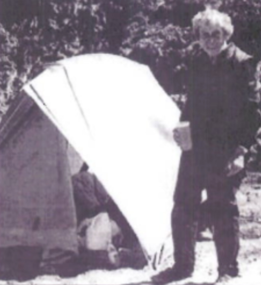 Caroline Musgrove Coons at the entrance to a tent.