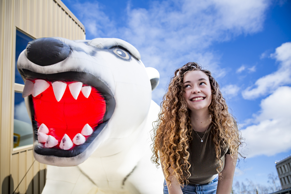 Sophia Martin poses nect to an inflatable Nook. UAF Photo by Sarah Manriquez