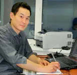 A man sitting at desk in front of a computer