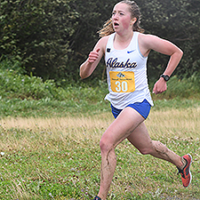 Woman running cross country. Photo courtesy of UAA.