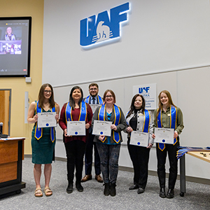CBSM Honors students receive their pin and sash as they're inducted into the Order of Sword and Shield and Betta Gamma Sigma. UAF photo by Leif Van Cise.