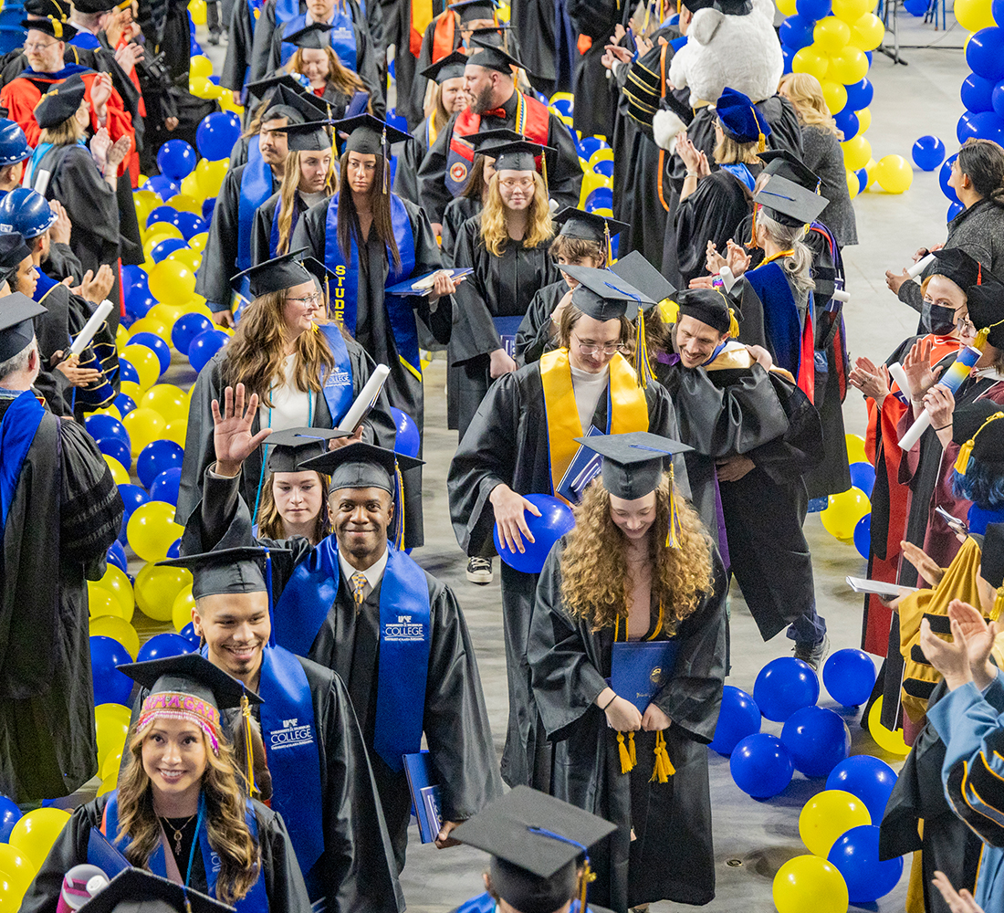 UAF graduates exit the Carlson Center at the end of the 2025 commencement ceremony. UAF Photo by Leif Van Cise.