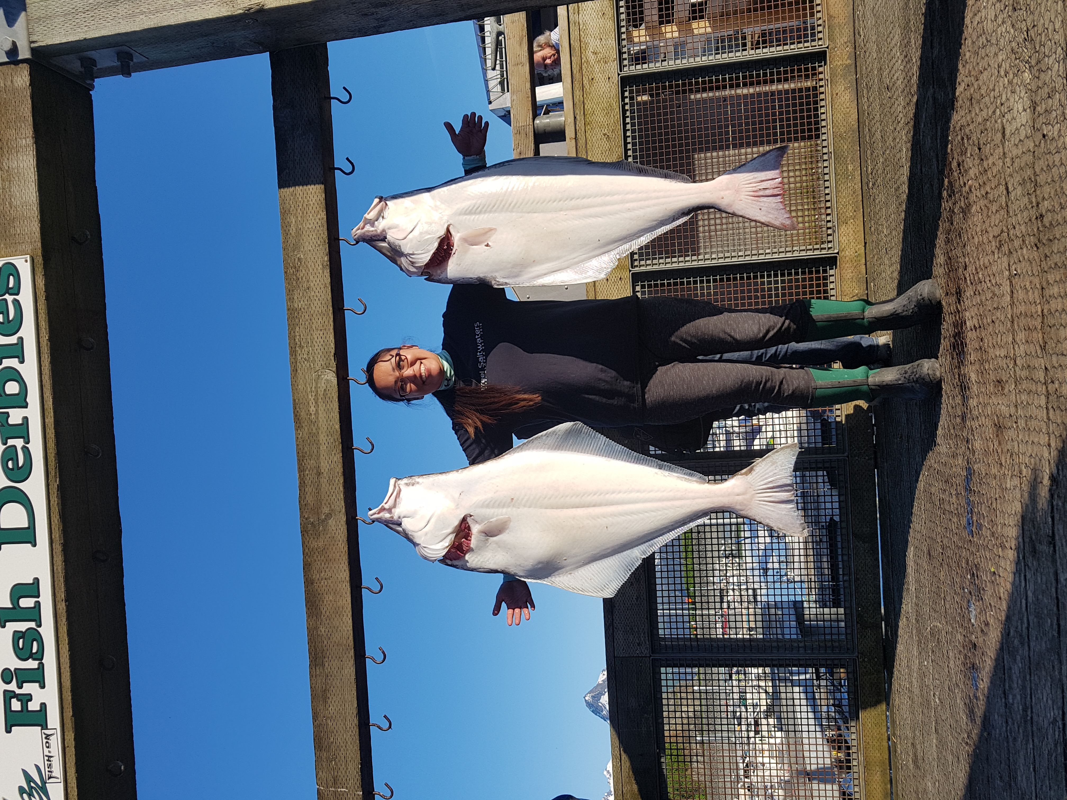 Hope Roberts stands with some halibut. See caption and credits below for more information.